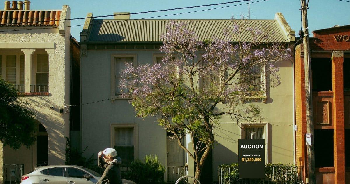 An auction sign outside a Melbourne house showing a published reserve price