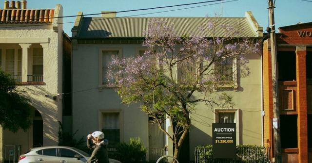 An auction sign outside a Melbourne house showing a published reserve price